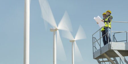 workers in front of wind array
