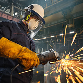 worker grinding metal with sparks