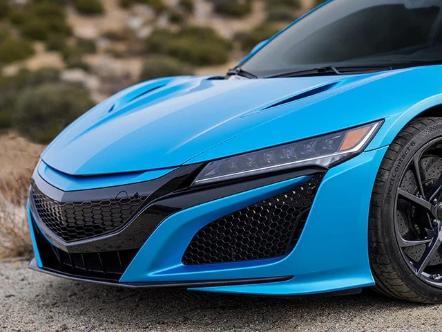 Close up of sports car front hood area with ocean shimmer blue colour car wrap film
