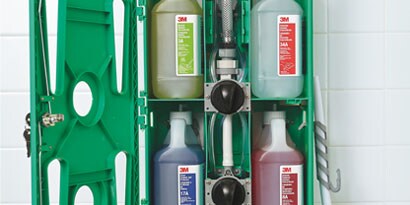 A 3M™ Chemical Management System contains four bottles of chemicals for commercial cleaning.
