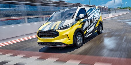 A panel van streaking across the finish line wrapped in a vibrant car graphics film
