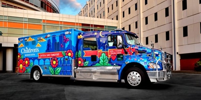 children’s hospital emergency vehicle shown in both daylight and nighttime with a full reflective graphic film wrap
