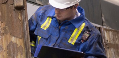Man working outside on truck wearing PPE
