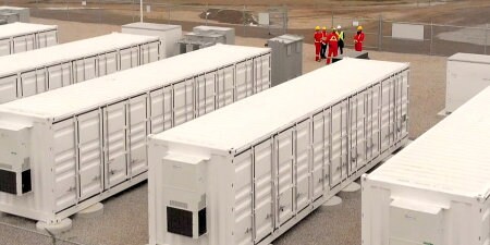 image of workers near battery array

