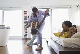 a family enjoying a warm winter inside their home as a result of 3M thinsulate window films being installed on their windows.