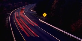 Long exposed image of highway at night with red and yellow light trails
