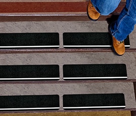 Overhead view of person walking down stairs with safety treads.
