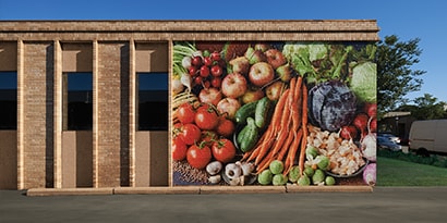 An exterior graphic wrap displays an image of colourful vegetables.
