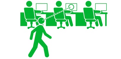 Illustration of a person looking at screens in an open office environment
