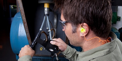 Electrician wraps motor leads with rubber electrical tape
