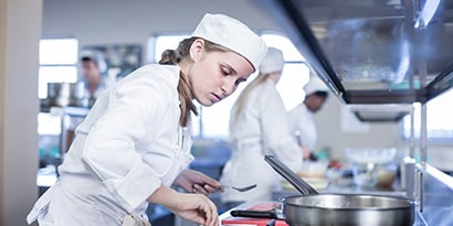 woman cooking in restaurant
