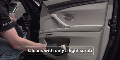 A person cleaning a car door