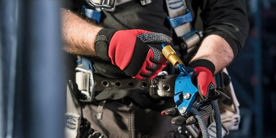 Close up of worker's hands using fall protection ppe
