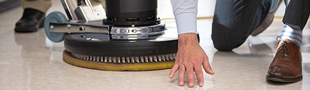Employee inspecting a recently polished coated concrete floor.
