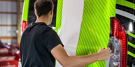 Installer holding IJ280 car graphics film panel

