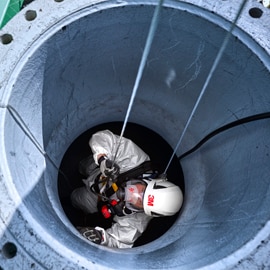 Image of a worker wearing PPE entering a confined space