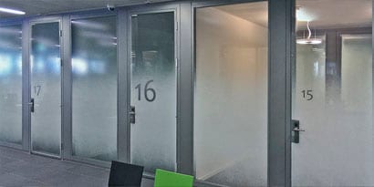 frosted glass doors on corporate meeting rooms to provide employee privacy
