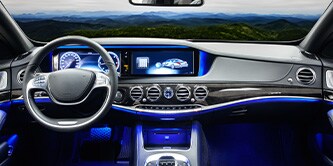 The steering wheel and dashboard view of a vehicle  
