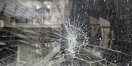 Close-up view of a window with shattered glass

